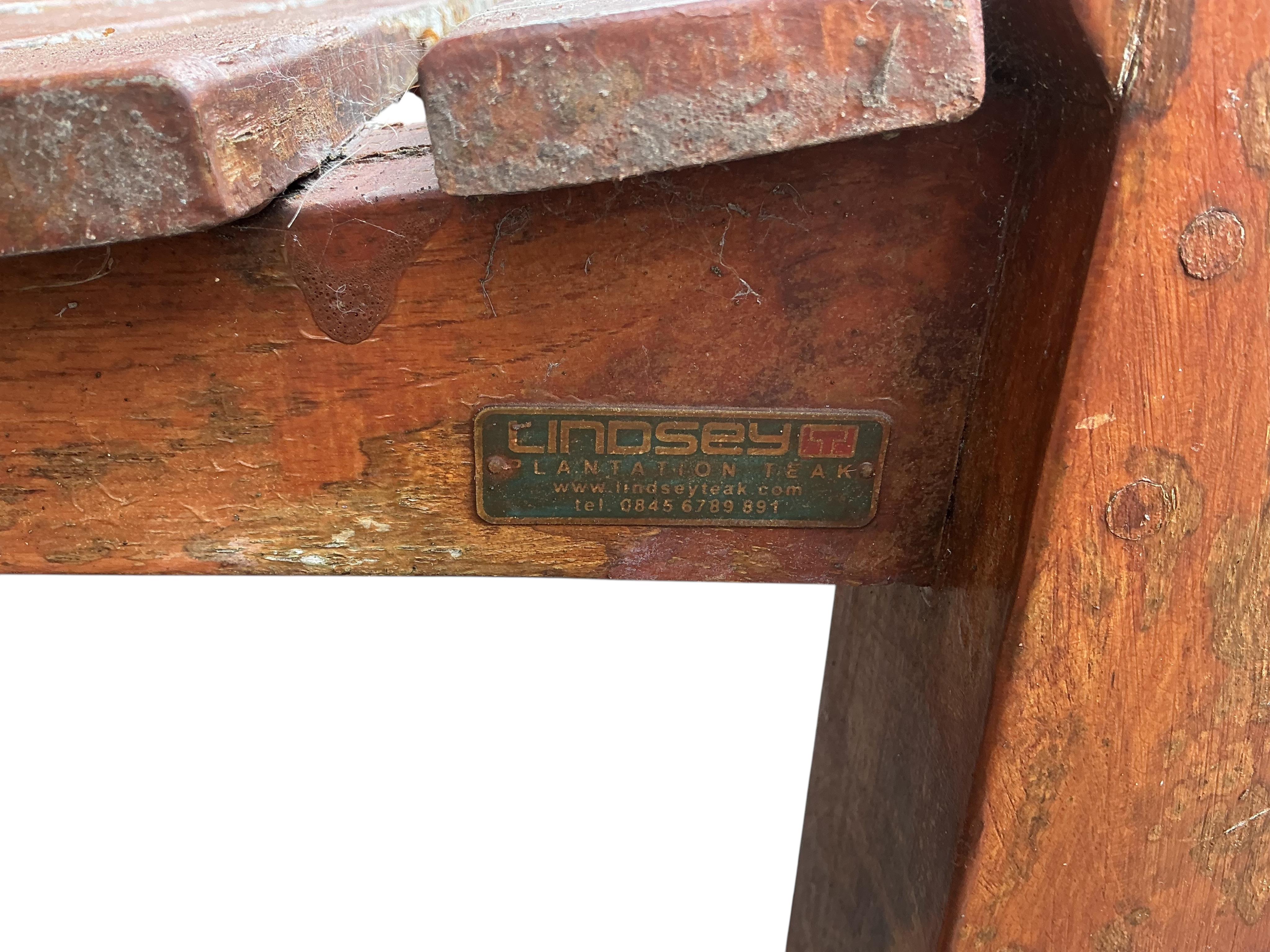 A Lindsey weathered stained teak garden bench, width 180cm, depth 66cm, height 94cm